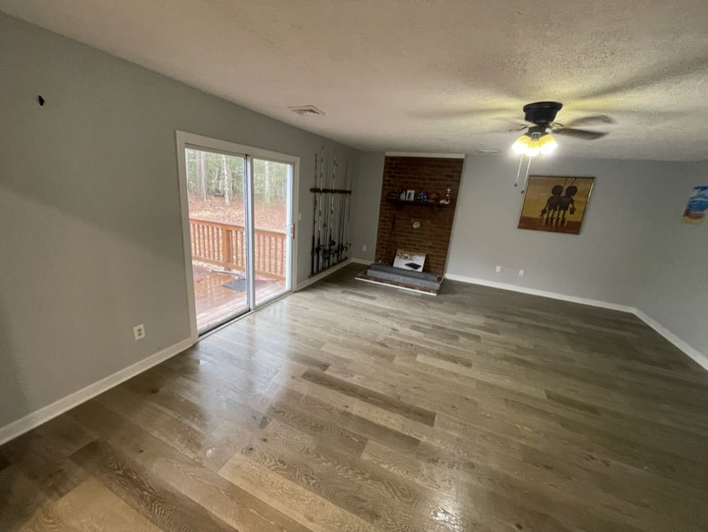 The same family room after installation, with the new flooring finished wall to wall