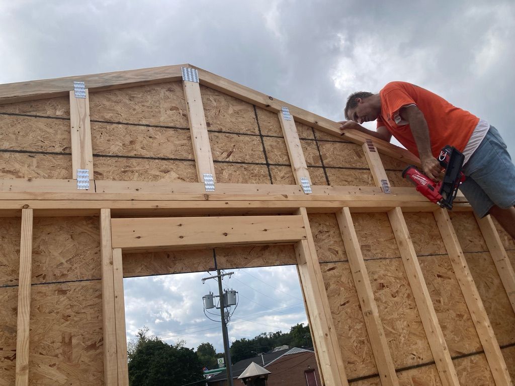 Crew member framing a wall and window opening in new construction